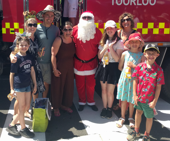 A family group supporting Santa Guss