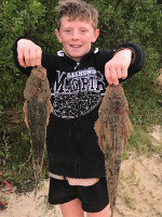 Young lad with two handy Flathead at Lake Tyers Beach
